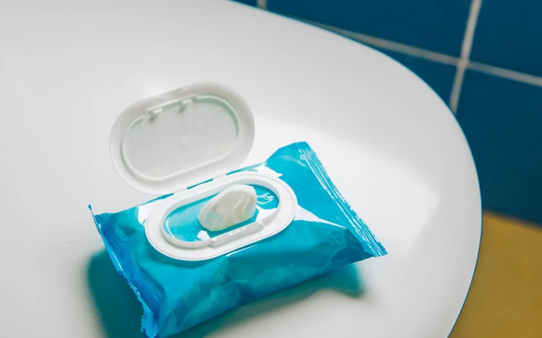 Package of flushable wipes sitting on a white bathroom counter
