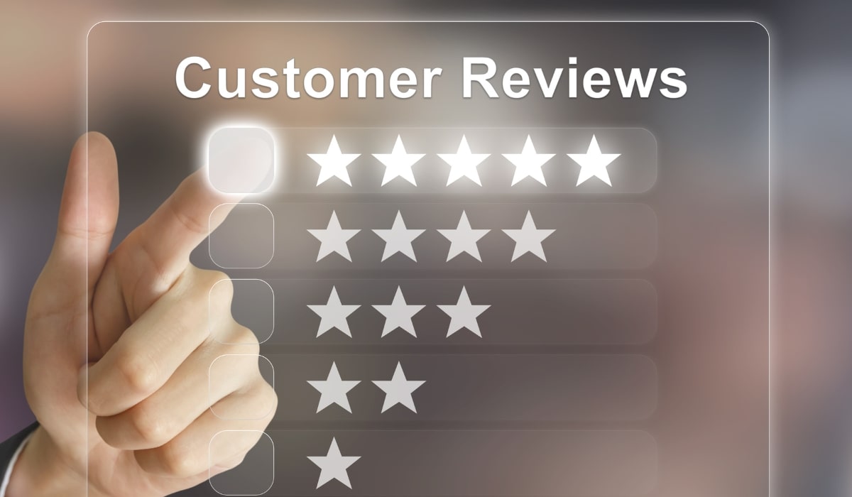 a hand touching a 5 star review image