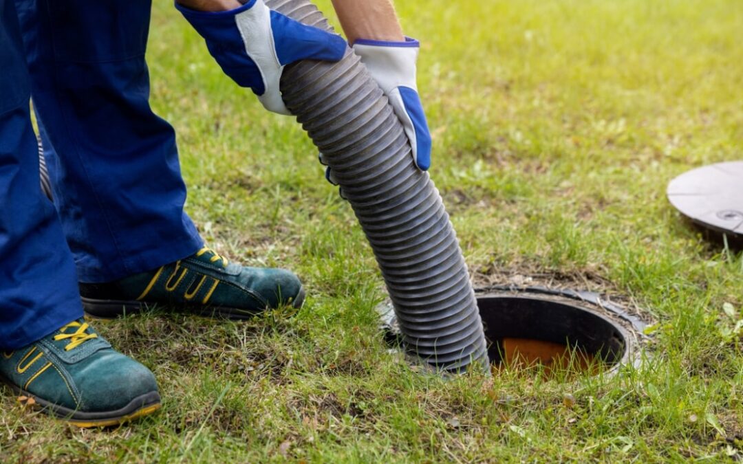 man draining sewer overflow
