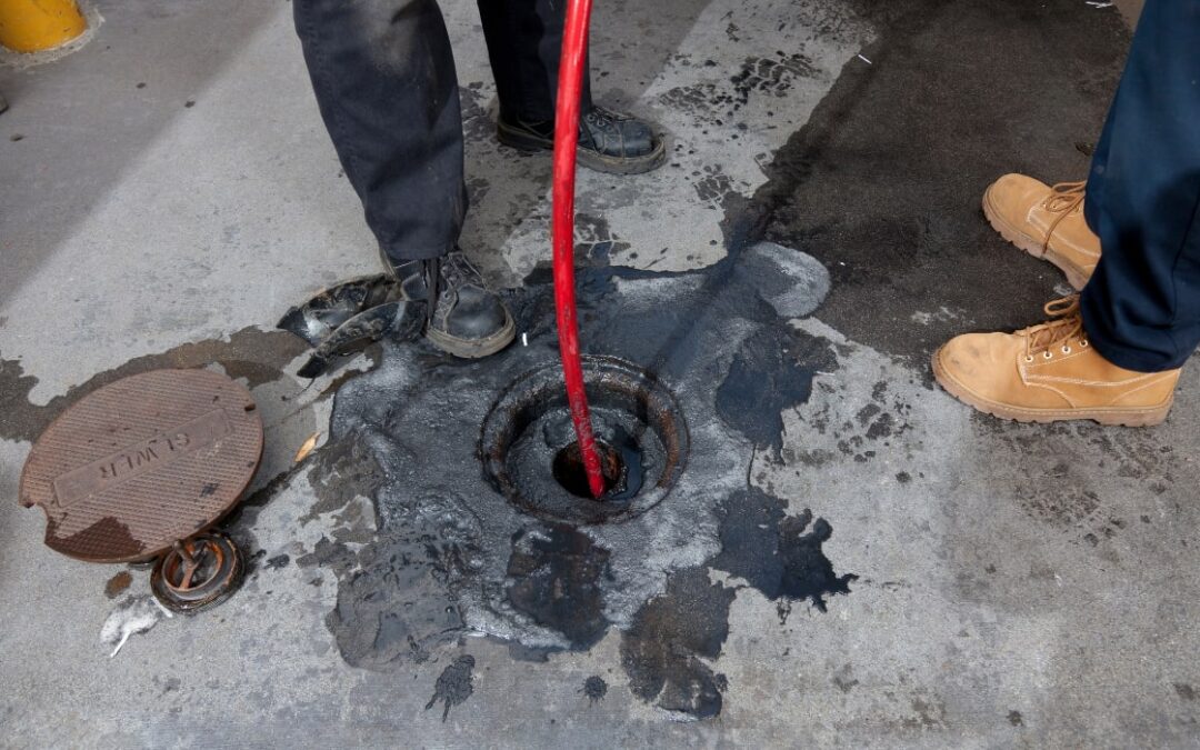 workers hydro jetting a sewer line